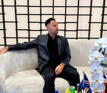 Victor Salazar seated in a lounge with state flags, getting a mortgage when moving to a new state