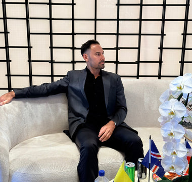 Victor Salazar seated in a lounge with state flags, getting a mortgage when moving to a new state