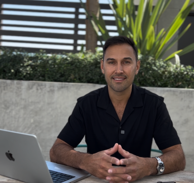 Victor Salazar seated at an outdoor table with a laptop, mortgage broker near me at Kings of Lending